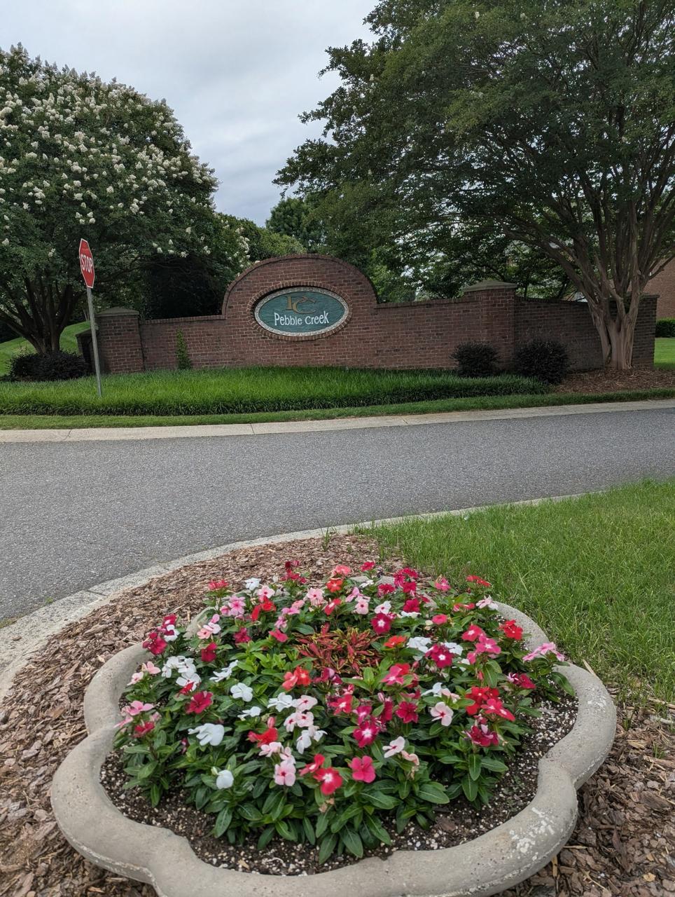 Pebble Creek entrance flowers and planter